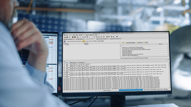 An engineer thinking in front of two monitors showing Questa Analyze Fault data.