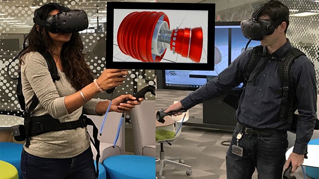 A man and a woman using virtual reality headsets to view something in NX CAD