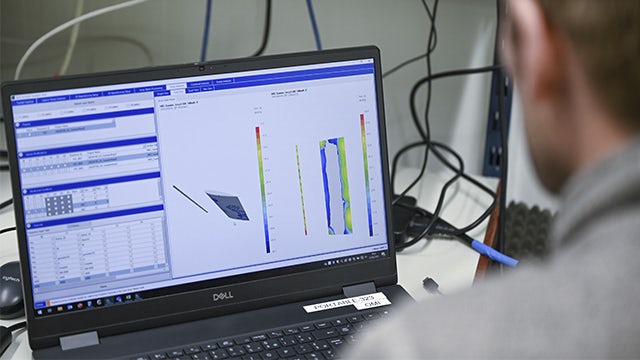A person using Simcenter sound source localization software on a laptop.