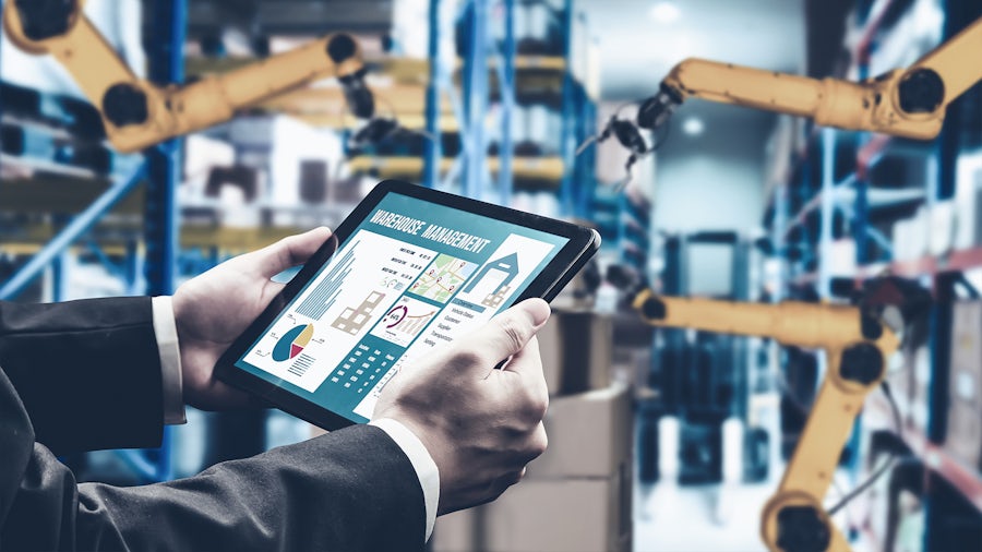 A person holding a table in a robotic factory