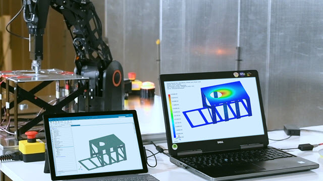 Real-time simulation of a metal plate when physical robot pushes down on the plate enabled by Simcenter 3D 2406