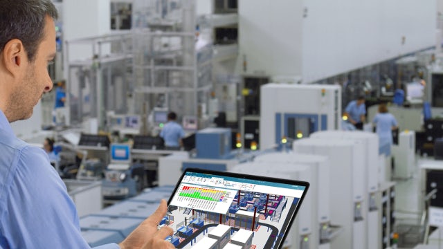 A male is overseeing a factory production environment and analyzing the throughput on an iPad using Plant Simulation X software.