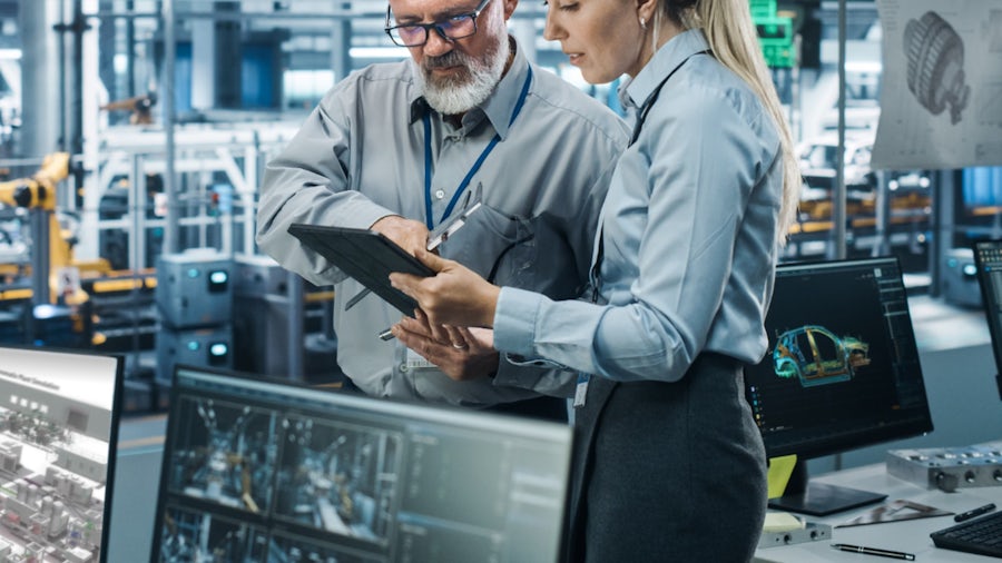 Two colleagues work on a battery-machinery-as-a-service model in a modern factory setting