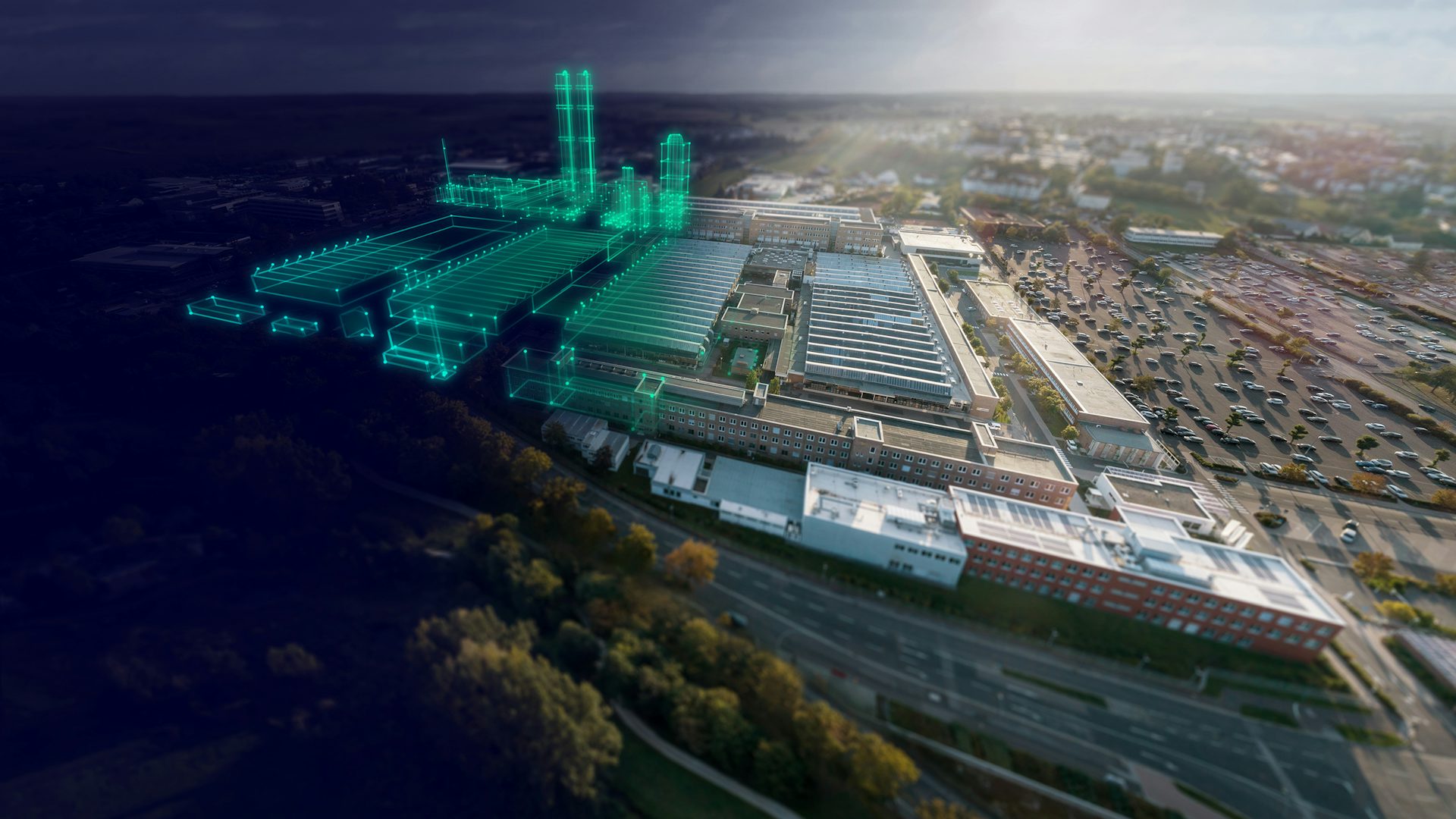 緑色のデジタルオーバーレイが展開された工場の航空写真。