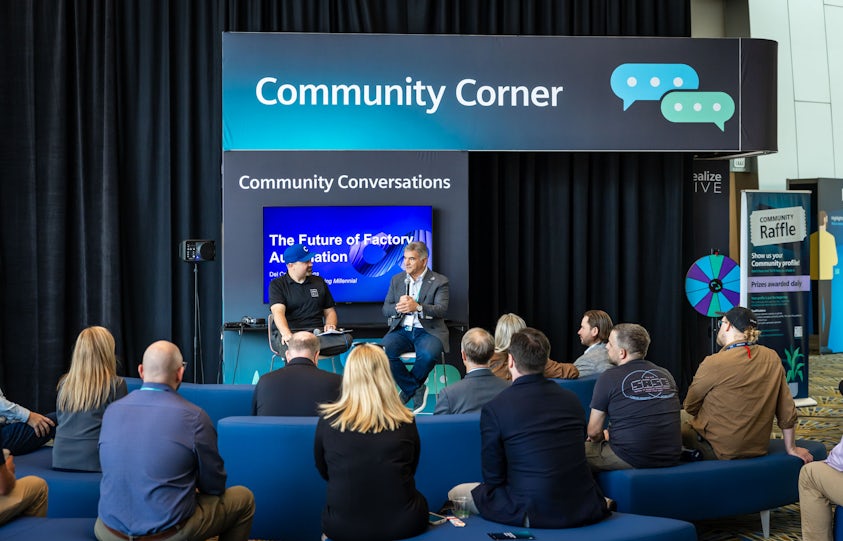 Realize LIVE Europe digital transformation conference participants have a discussion at the Community Corner.