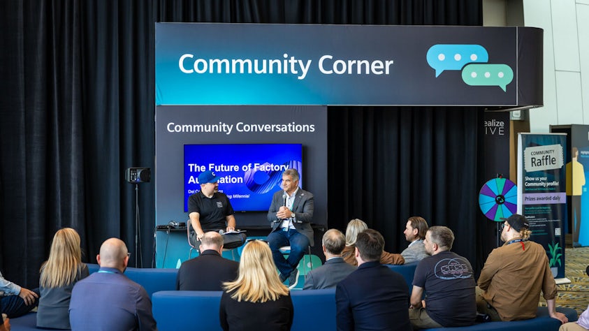 Realize LIVE Europe digital transformation conference participants have a discussion at the Community Corner.