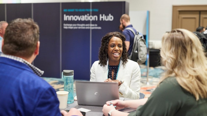 Realize LIVE Europe digital transformation conference participants have a discussion at the Community Corner.
