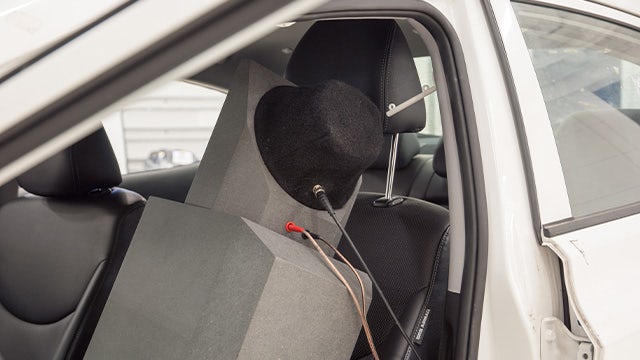 Simcenter low-mid frequency source unit is placed on a car seat.