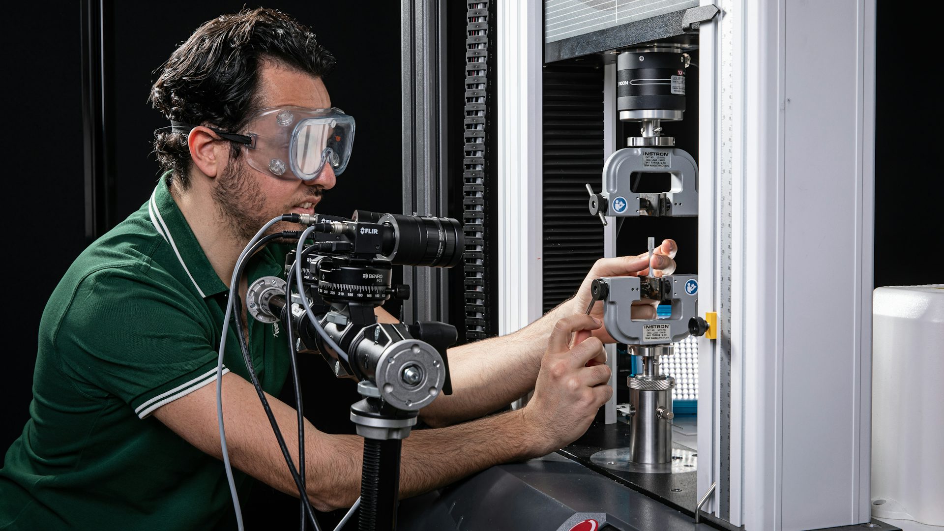 Engineer performing materials testing using a tool.