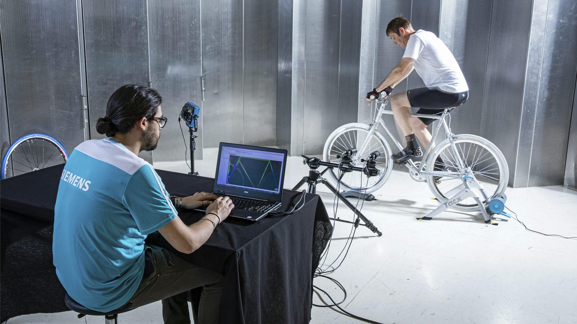 Man using digital image correlation (DIC) to measure 3D full-field data of a bicycle.
