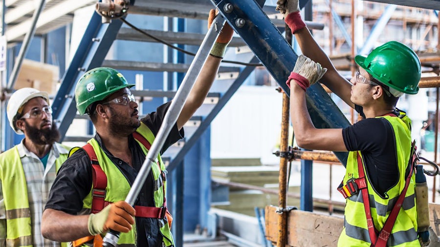 Construction workers leveraging systems-driven design to manage requirements and stay compliant.