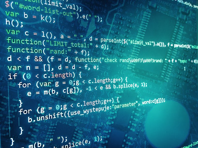 Software Code displayed over printed circuit board.