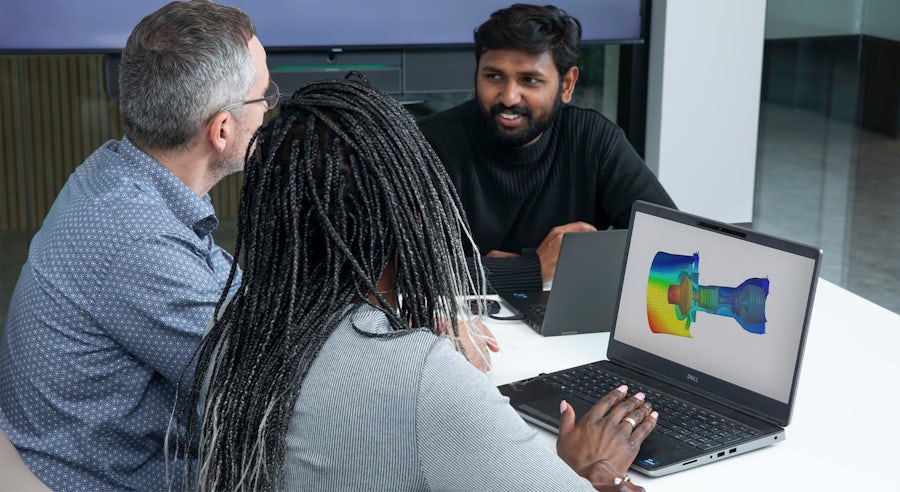 Group of people discussing Simcenter structural dynamics simulation.