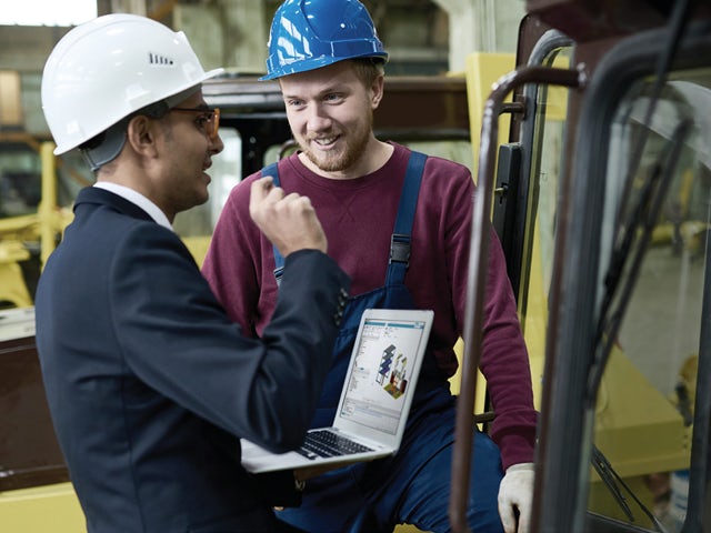 Manufacturing engineers in a heavy equipment factory.