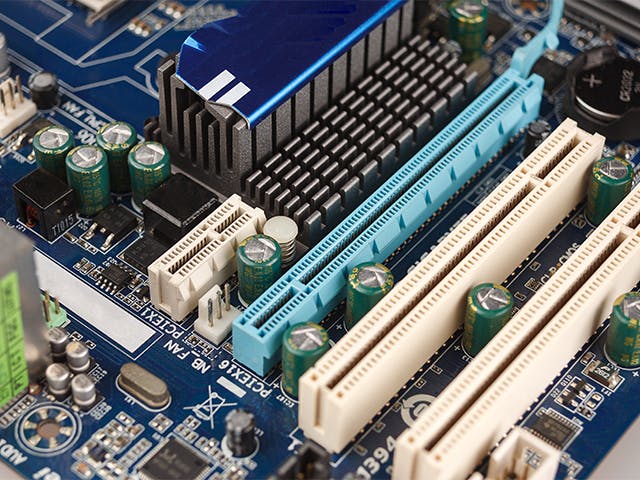 A computer motherboard with various PCIe connectors.