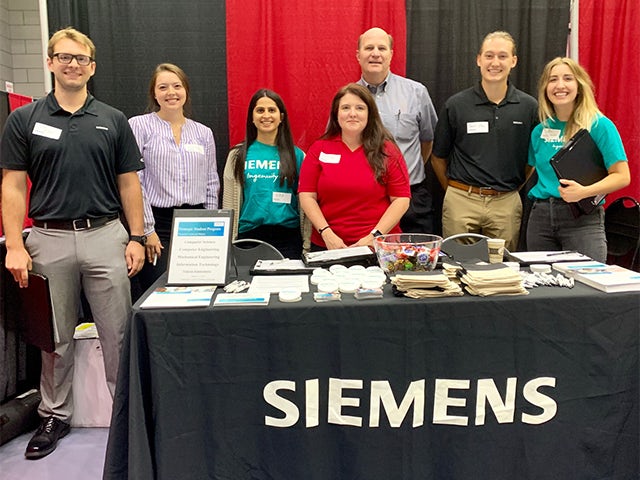 Siemens employees and university relations team at a job fair for recent graduates and interns 