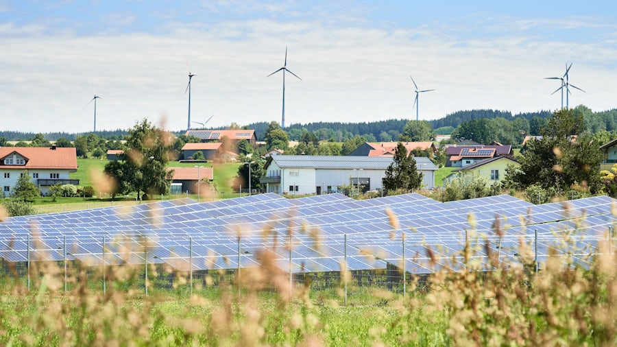 solar panels with houses in the back