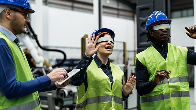 Engineers wearing virtual reality glasses.