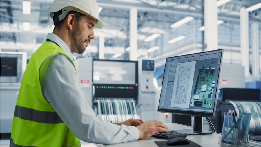 dude in white helmet at monitor