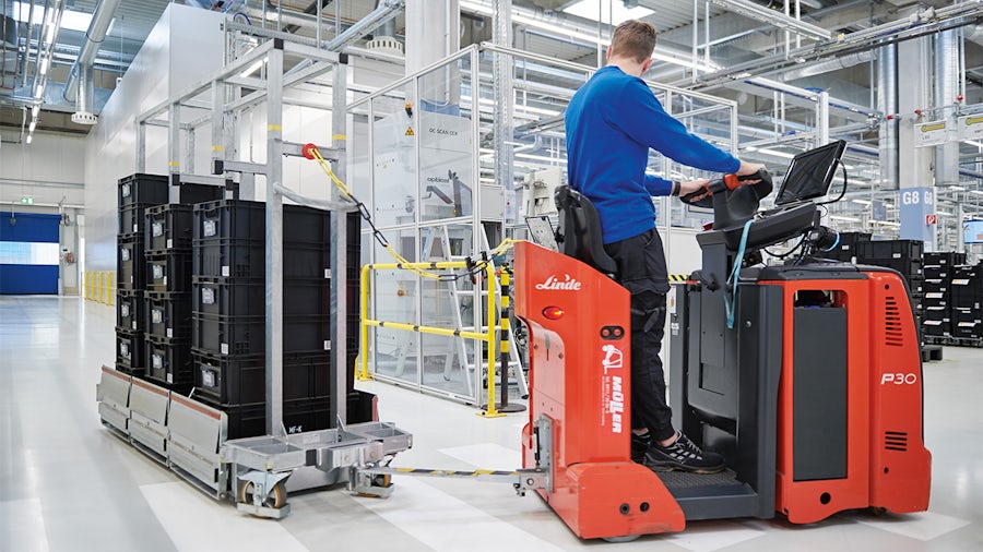 Worker in factory operating industrial machinery,