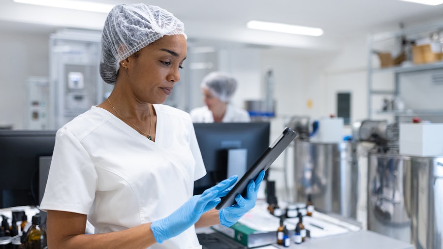 Engineer looking at a tablet using Siemens' Mendix platform.