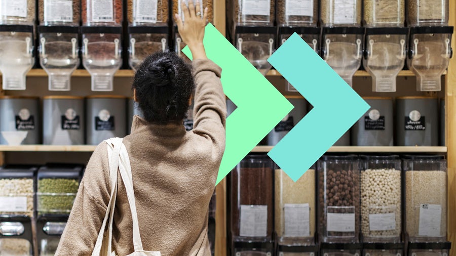 A consumer at the grocery store reaching for food.