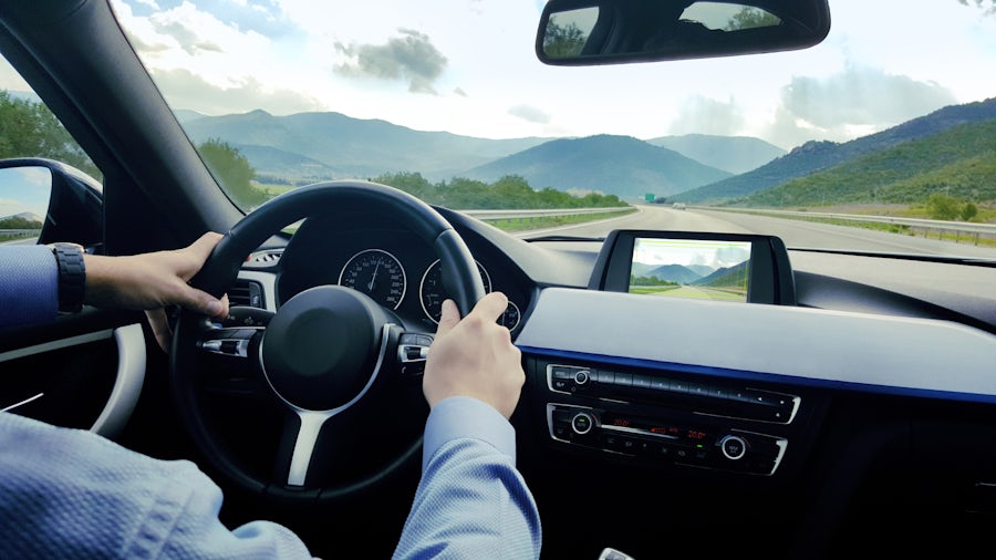 Driver with hands on steering wheel