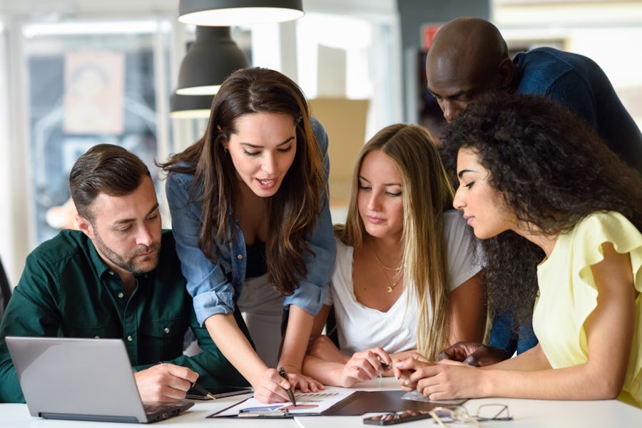 A group of students discussing at the desk