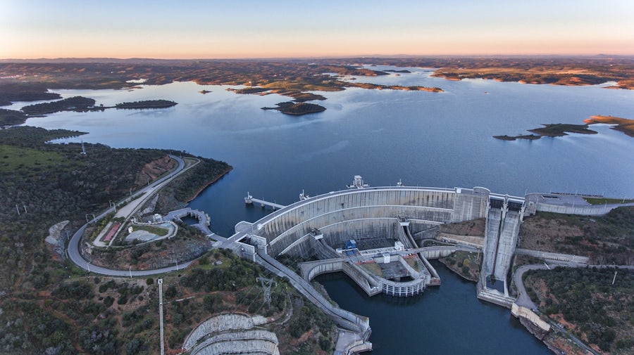 Hydroelectric dam with lake at sunset