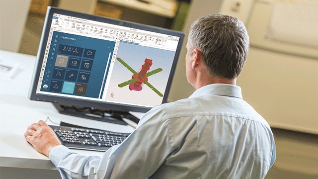 A man at the desktop computer working on Simcenter 3D.