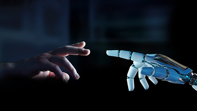 Human hand reaching toward a white robotic finger, about to make contact.