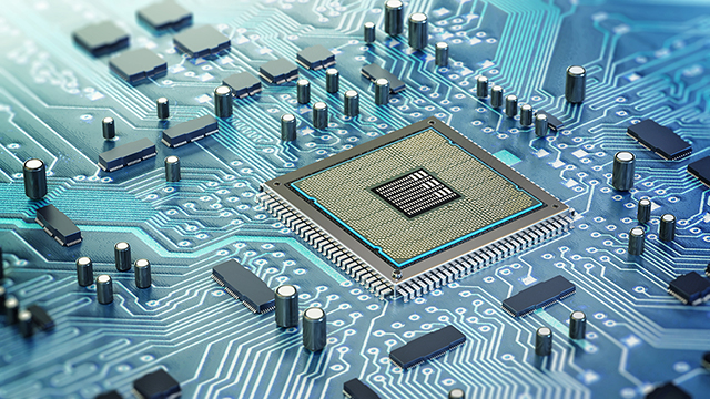 Close-up view of a computer chip embedded in a circuit board, surrounded by intricate electronic components.