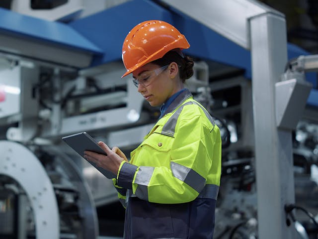 factory worker checking current production status
