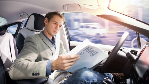 Man reading Mag 10 in car