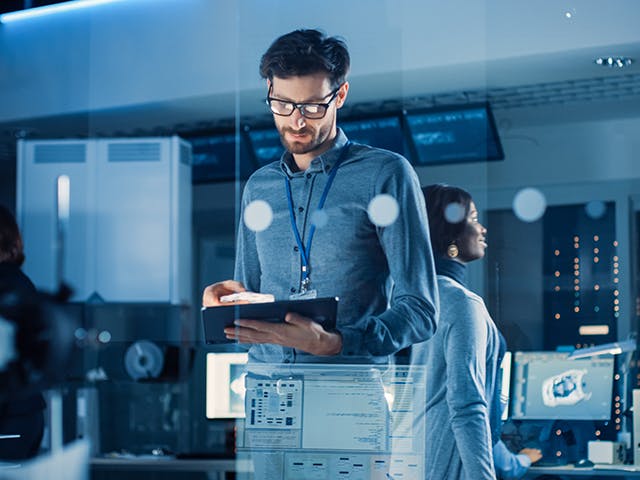 A design engineer uses a tablet to review the latest prototype specifications.