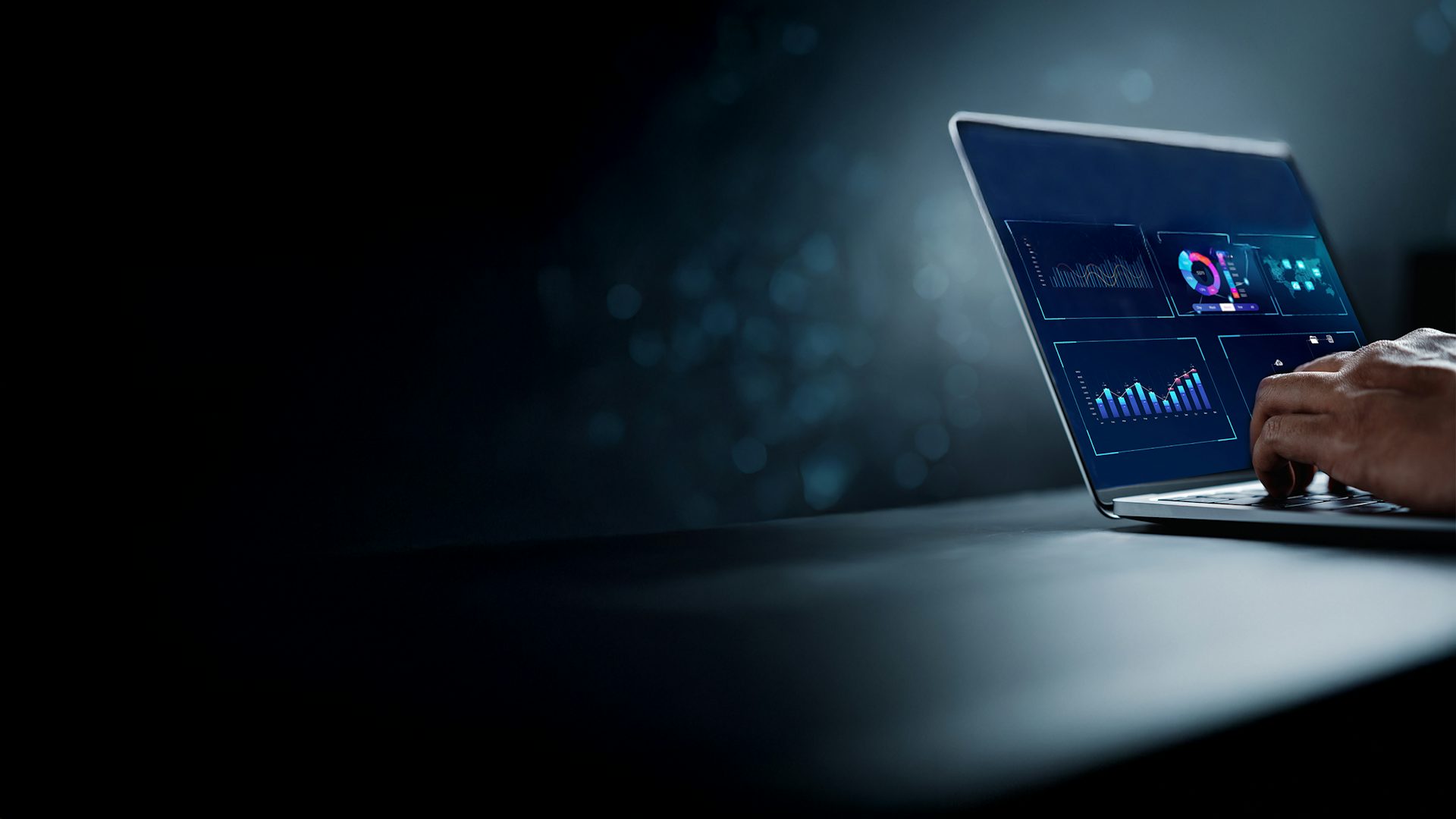 Analyst working on a laptop in a business analytics and data management system to generate reports with KPIs and metrics connected to a database.