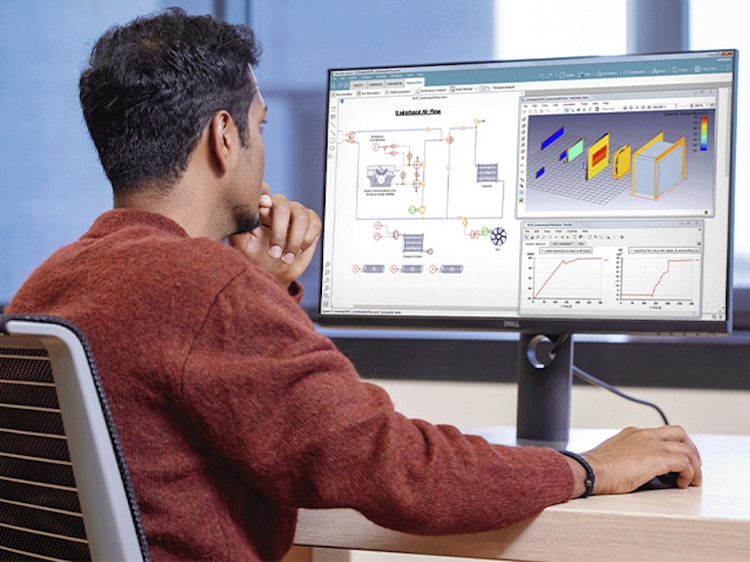 An engineer using the Simcenter systems simulation software on the desktop.