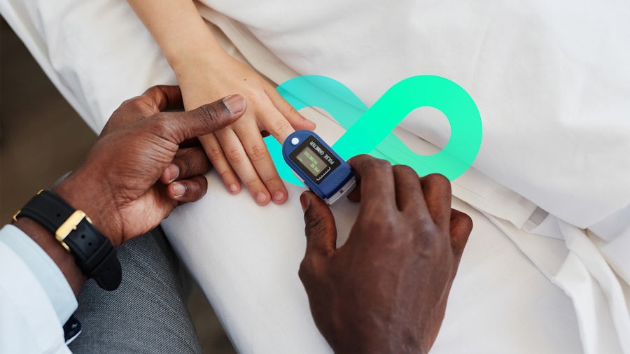 Medical professional putting oximeter on patient's finger.