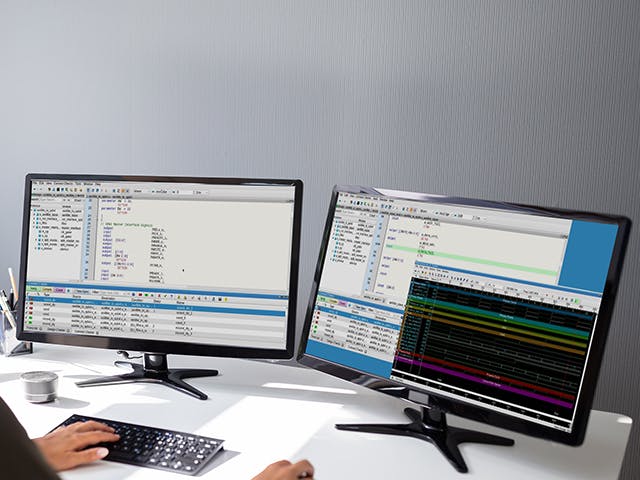 Engineer using Questa Check Connect Tool on her two monitors 