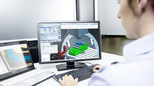 Engineer is working on a design shown on a laptop and a monitor 