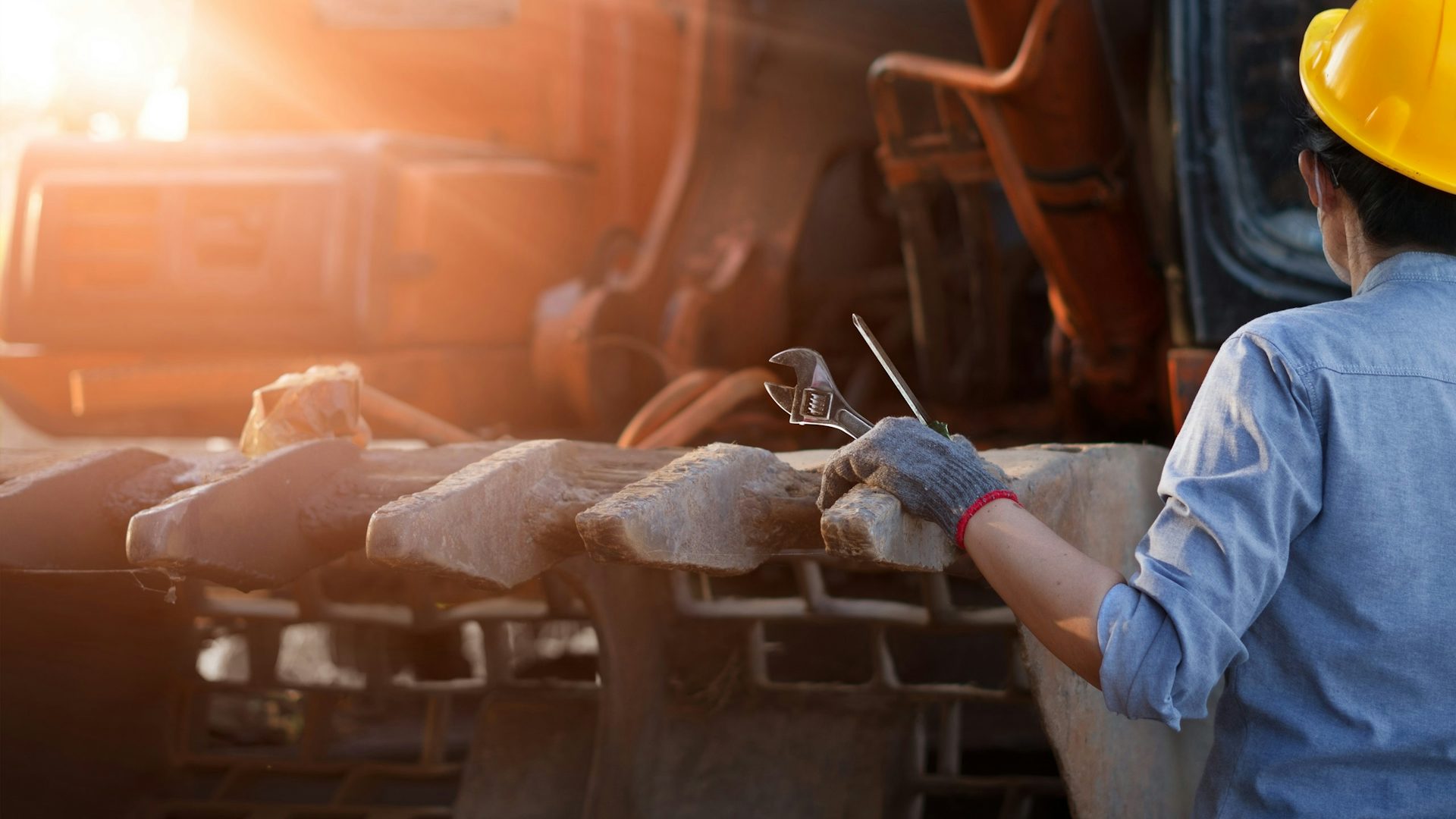 A worker operating a heavy machinery.