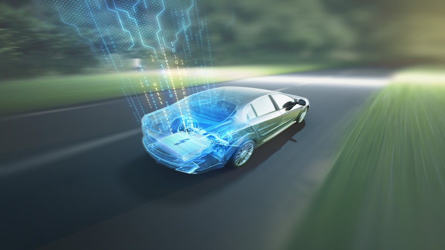 a graphic representation of autonomous vehicle technology overlayed onto a driving car going down the street.