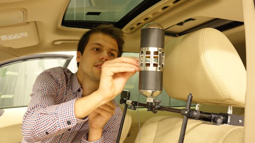 An engineer using a Simcenter Qsources hardware low-frequency monopole source device.