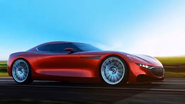 A red Mazda RX 9 coupe driving on a road