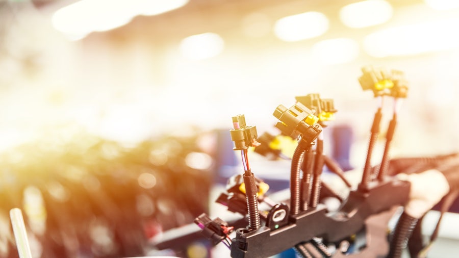 Image of a wiring harness on an assembly line in a wire harness manufacturing facility