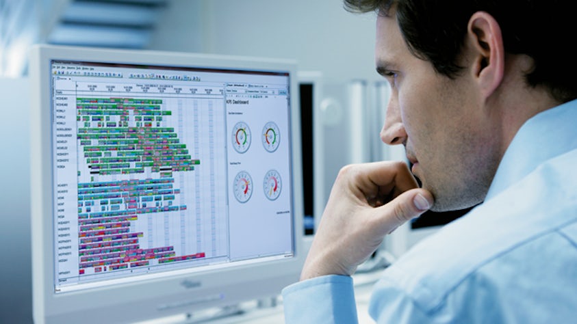 Man looks at a computer screen.