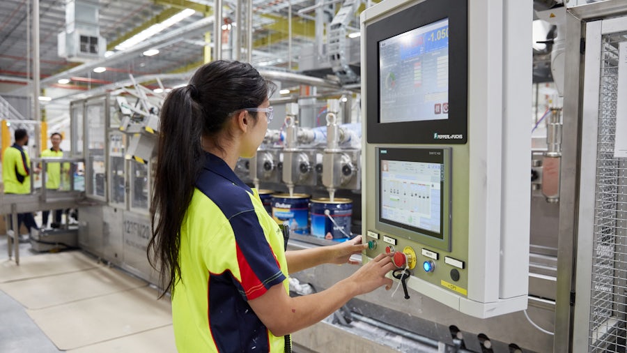 Un operatore della macchina utilizza soluzioni di smart manufacturing in un reparto produzione.