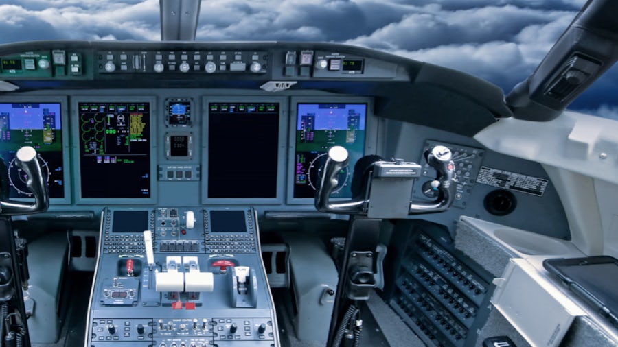 Picture of the inside of a commercial aircraft cockpit.