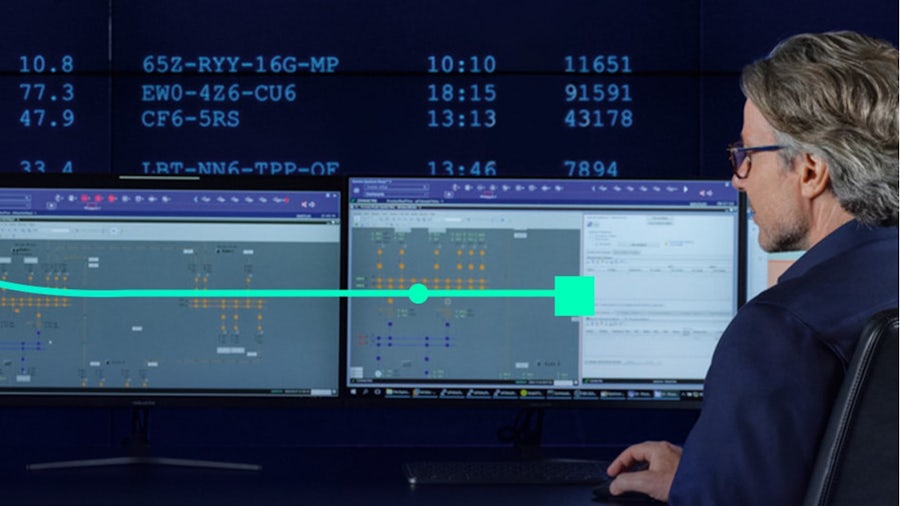 An IT worker looking at his monitor