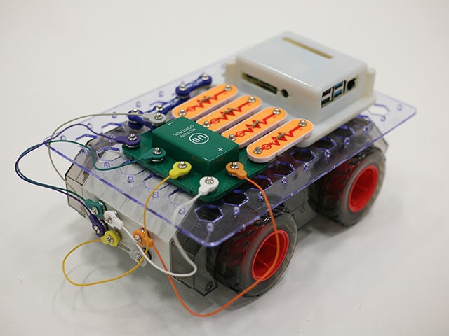 A robot built with wires and computer chips shaped in the size of a small car